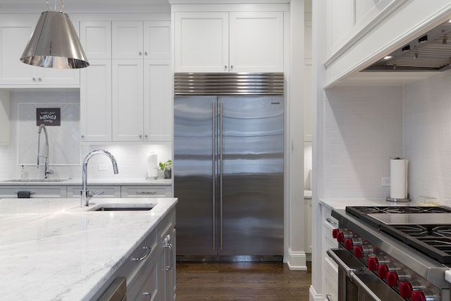 kitchen-with-white-furnishing-and-stainless-steel-appliances