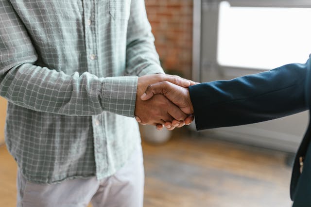 two-people-shaking-hands-in-a-professional-setting copy