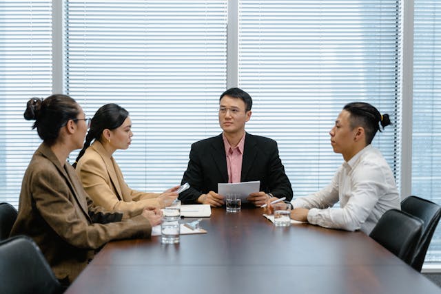 a-group-of-professionals-engaged-in-a-discussion-at-a-conference-table-in-an-office-setting
