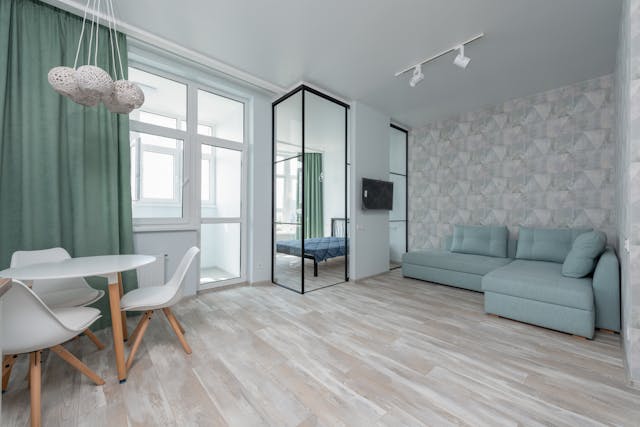 living-room-with-hardwood-floors-a-blue-couch-and-a-white-table