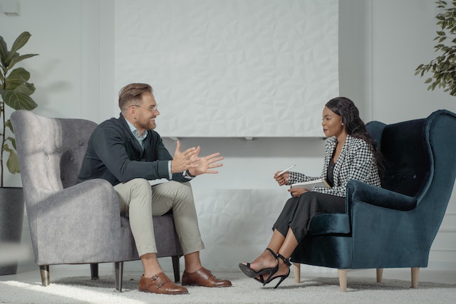 two-people-sitting-in-armchairs-having-a-discussion