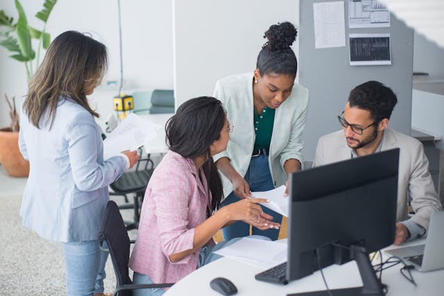 a-group-of-employees-working-at-a-desk-together