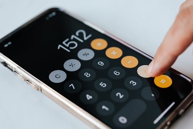 close-up-of-a-person-using-the-calculator-app-on-a-smartphone-with-the-screen-displaying-the-number-1512