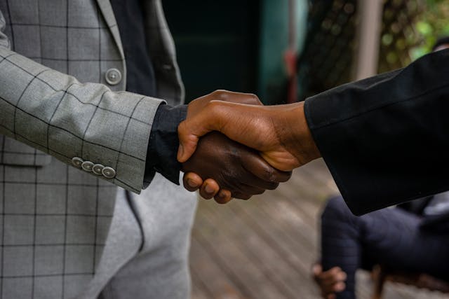 two-people-shaking-hands-in-a-professional-setting