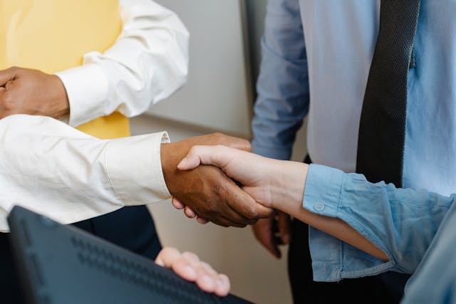 a-close-up-of-two-people-shaking-hands