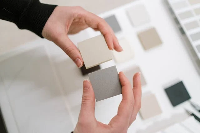 a-person-looking-at-paint-and-tile-samples