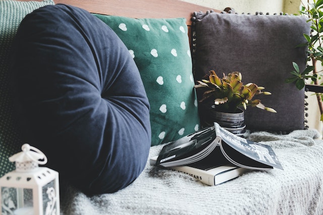 a-couch-with-cushions-and-a-book