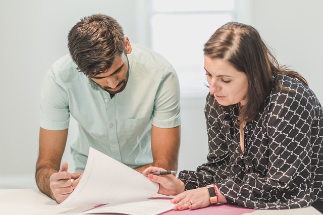 a tenant and property manager looking over a lease contract