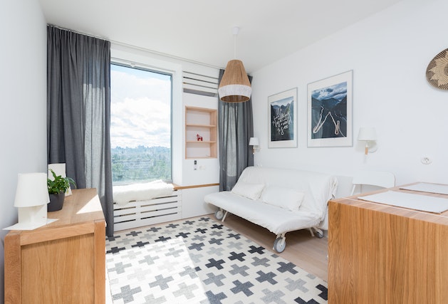 apartment living room with a white couch and blue curtains