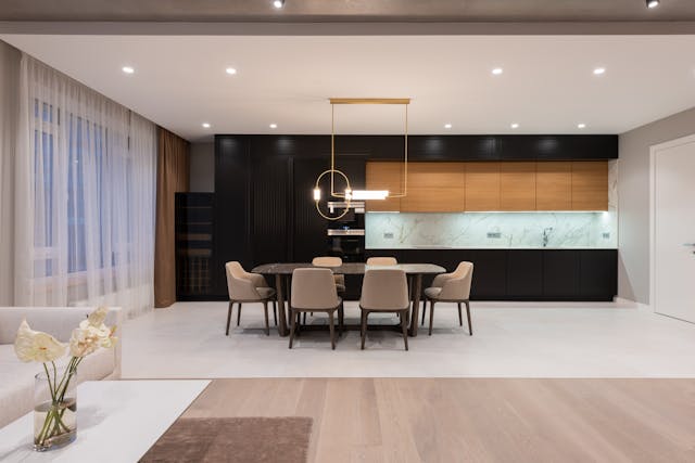 dinning-room-with-black-cupboards-and-a-light-table