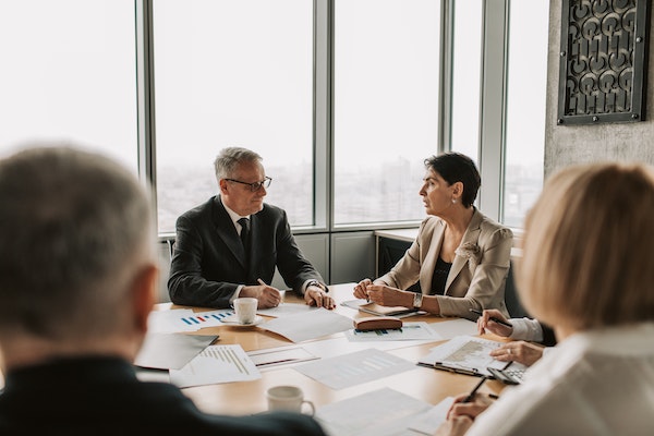 four real estate experts sitting around a conference table during a meeting