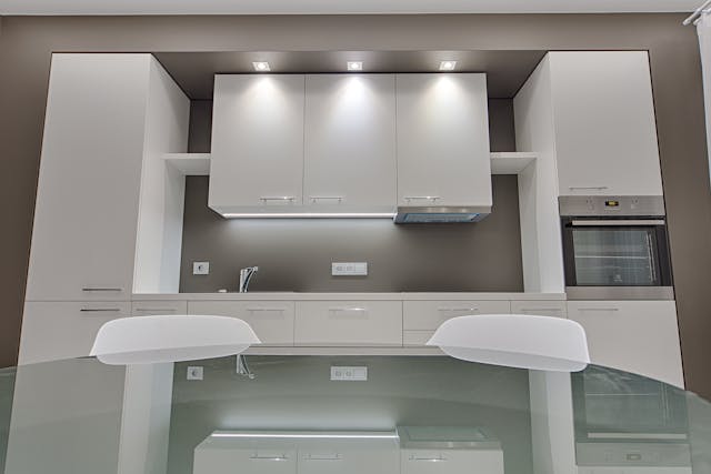 kitchen-with-a-glass-kitchen-table-and-white-cupboards