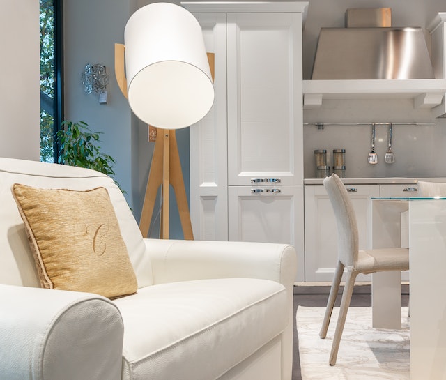 living room with a white linen couch and large white lighting feature