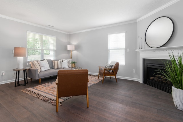 living room with dark wood floors a grey couch and brown arm chairs