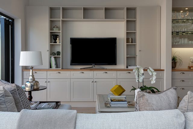 neutral-living-room-with-a-couch-facing-a-flat-screen-tv