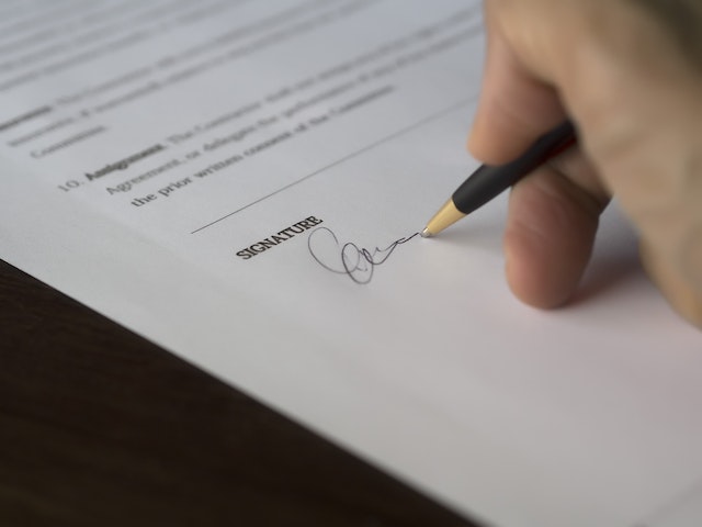 person-signing-their-signature-on-a-lease-agreement
