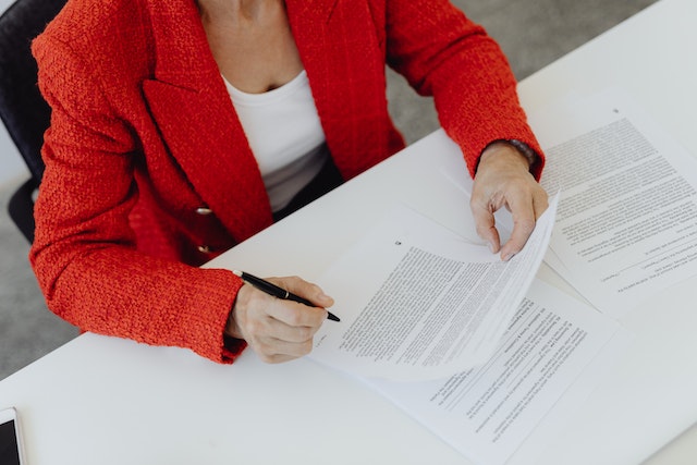 landlord in a red suit jacket roving a contracts policies