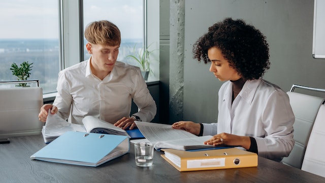 two property managers sitting in a conference room looking over reports