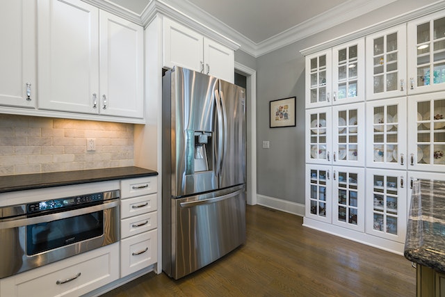 kitchen with a two-door stainless steal fridge and white cabinets