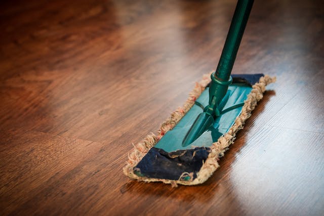 person-mopping-the-hardwood-floors