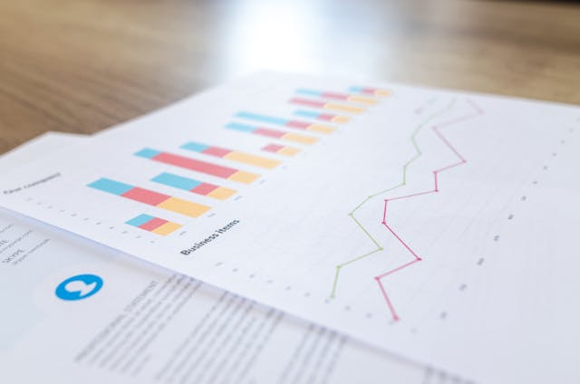 a-document-with-colorful-bar-and-line-graphs-on-a-wooden-desk