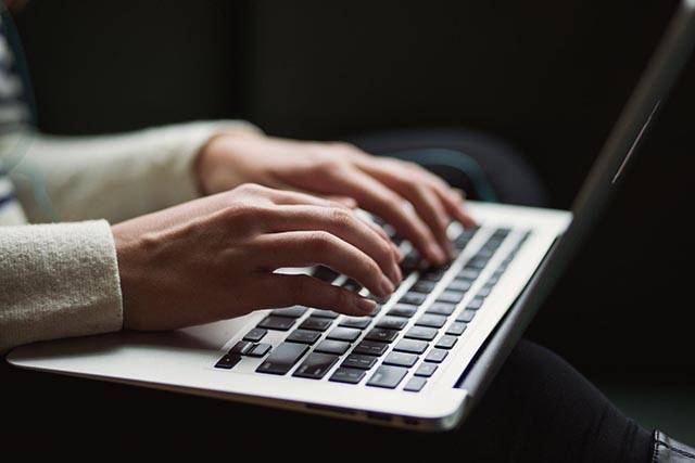 a-person-typing-on-a-laptop-keyboard