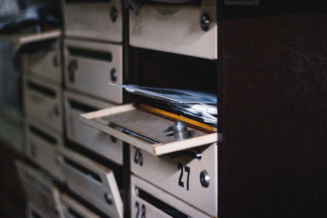 a-stack-of-letters-in-an-open-community-mailbox