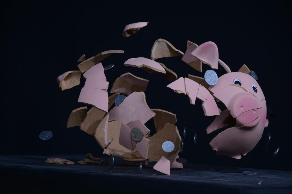 Broken Piggy Bank with Scattered Coinage