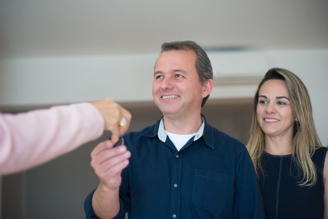 two people receiving a house key
