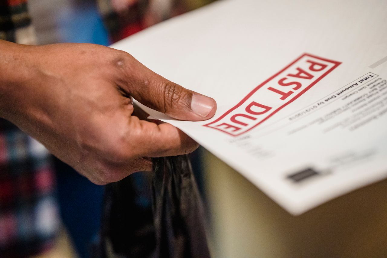 Person holding a past-due rent notice